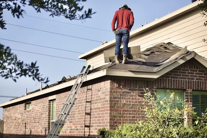 Professional roofer working on a residential roof in Heilwood